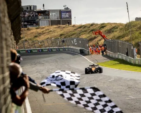 McLaren driver Lando Norris takes the chequered flag and wins the Dutch Grand Prix at Zandvoort