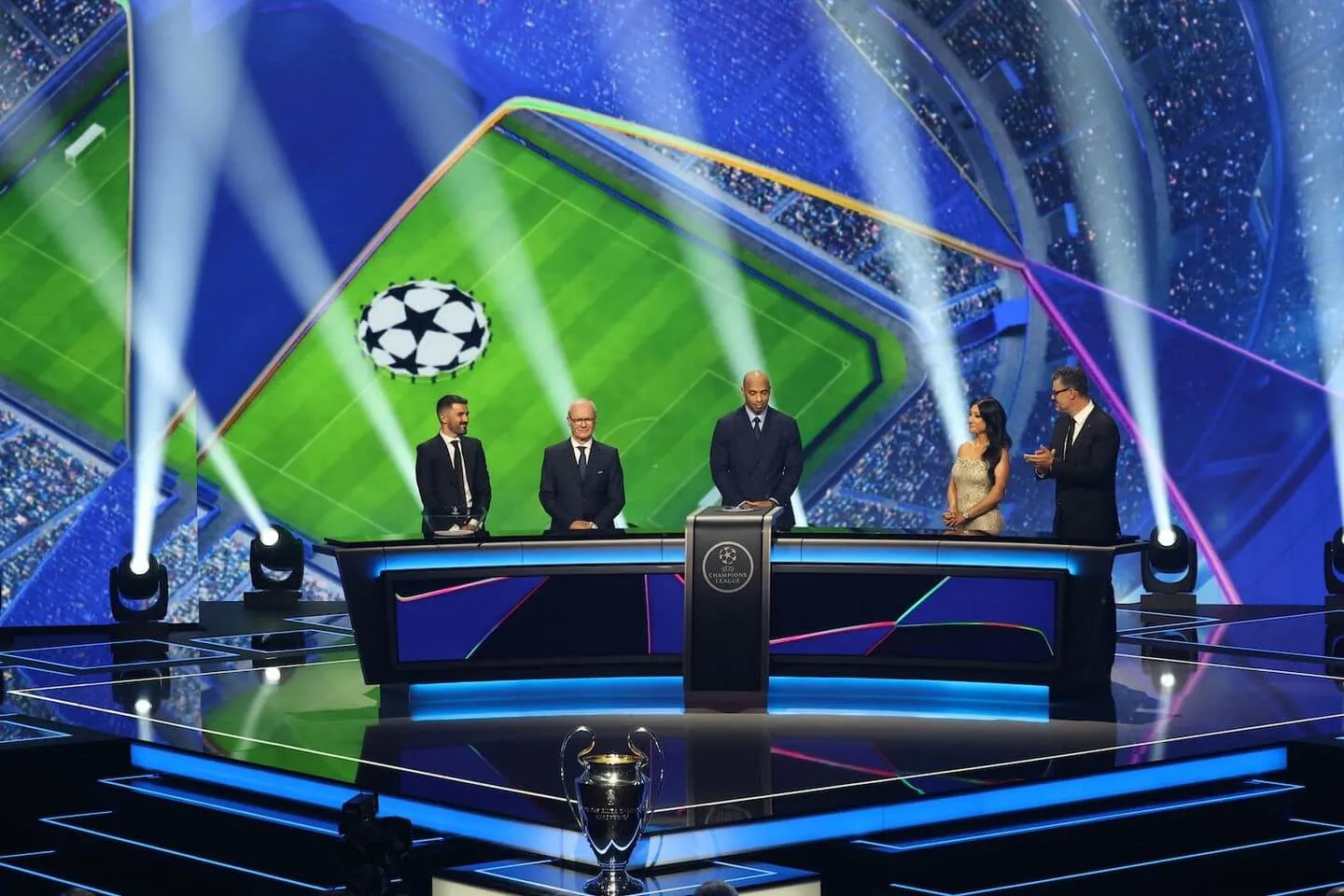 Spanish former football player David Villa, UEFA Deputy General Secretary Giorgio Marchetti, French former football player Thierry Henry, British-Bangladeshi sports journalist Reshmin Chowdhury and UEFA Managing Director of Communications Pedro Pinto are seen on the stage after the draw for the league phase of the 2026-2027 UEFA Champions League football tournament during a ceremony at the Grimaldi Forum in the Principality of Monaco on August 27, 2026.