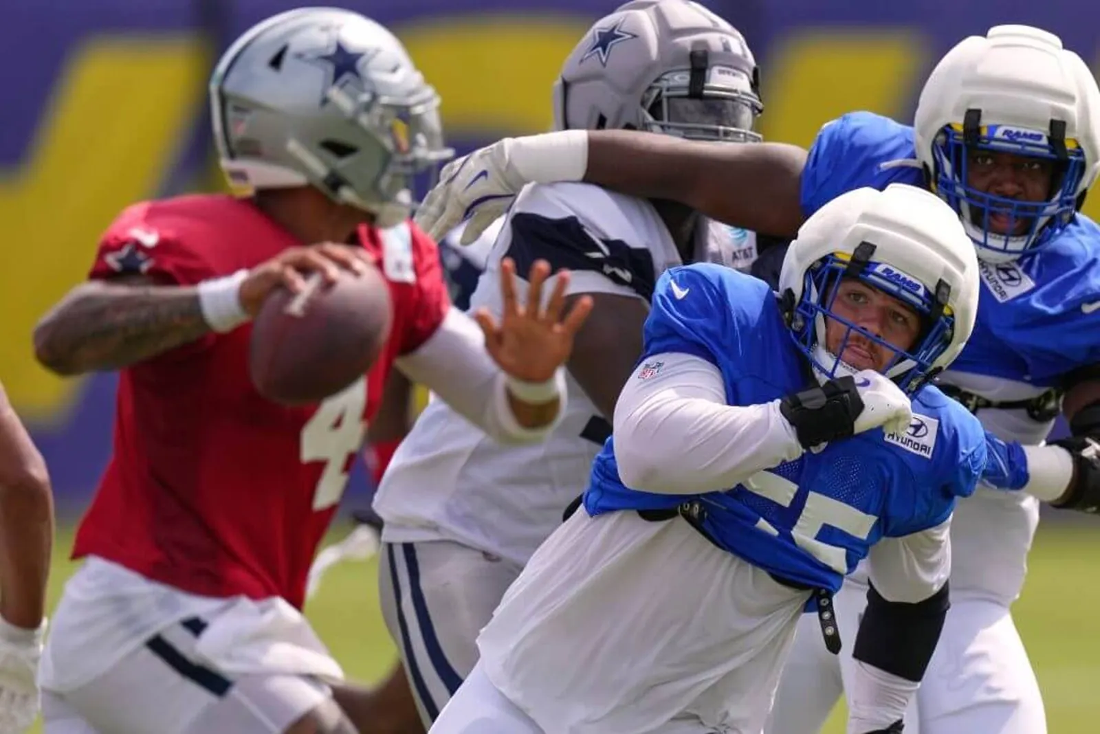 Los Angeles Rams defensive end Braden Fiske, lower right, goes after Dallas Cowboys quarterback Dak Prescott, left, during an NFL joint practice on Aug. 11, 2026 in Los Angeles.